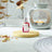 Tea Rose Fragrance Oil in the foreground with a lit Oil Burner in the background
