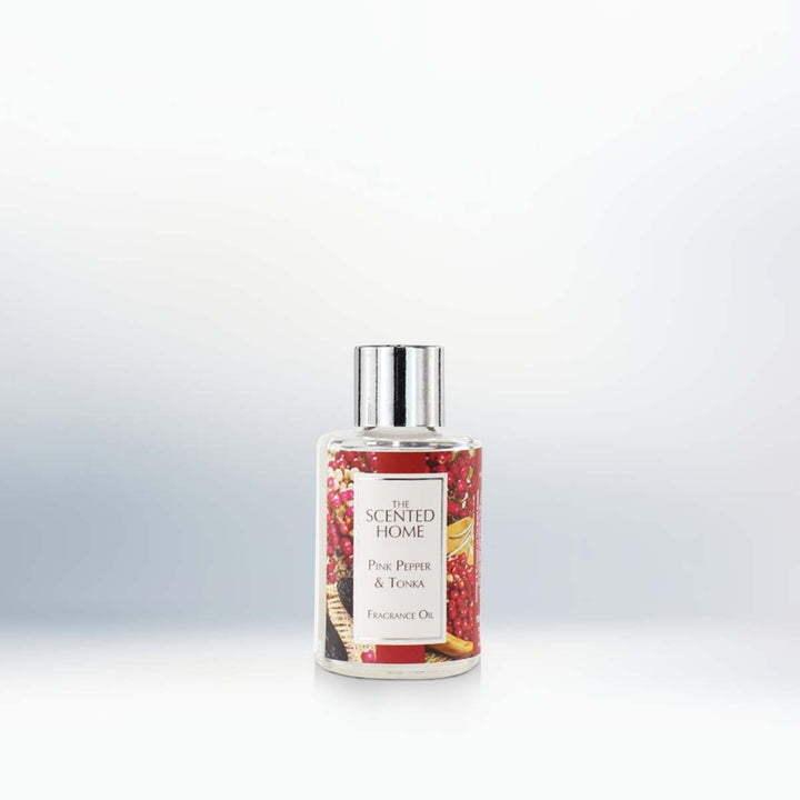 A bottle of Pink Pepper & Tonka Fragrance Oil on a neutral background