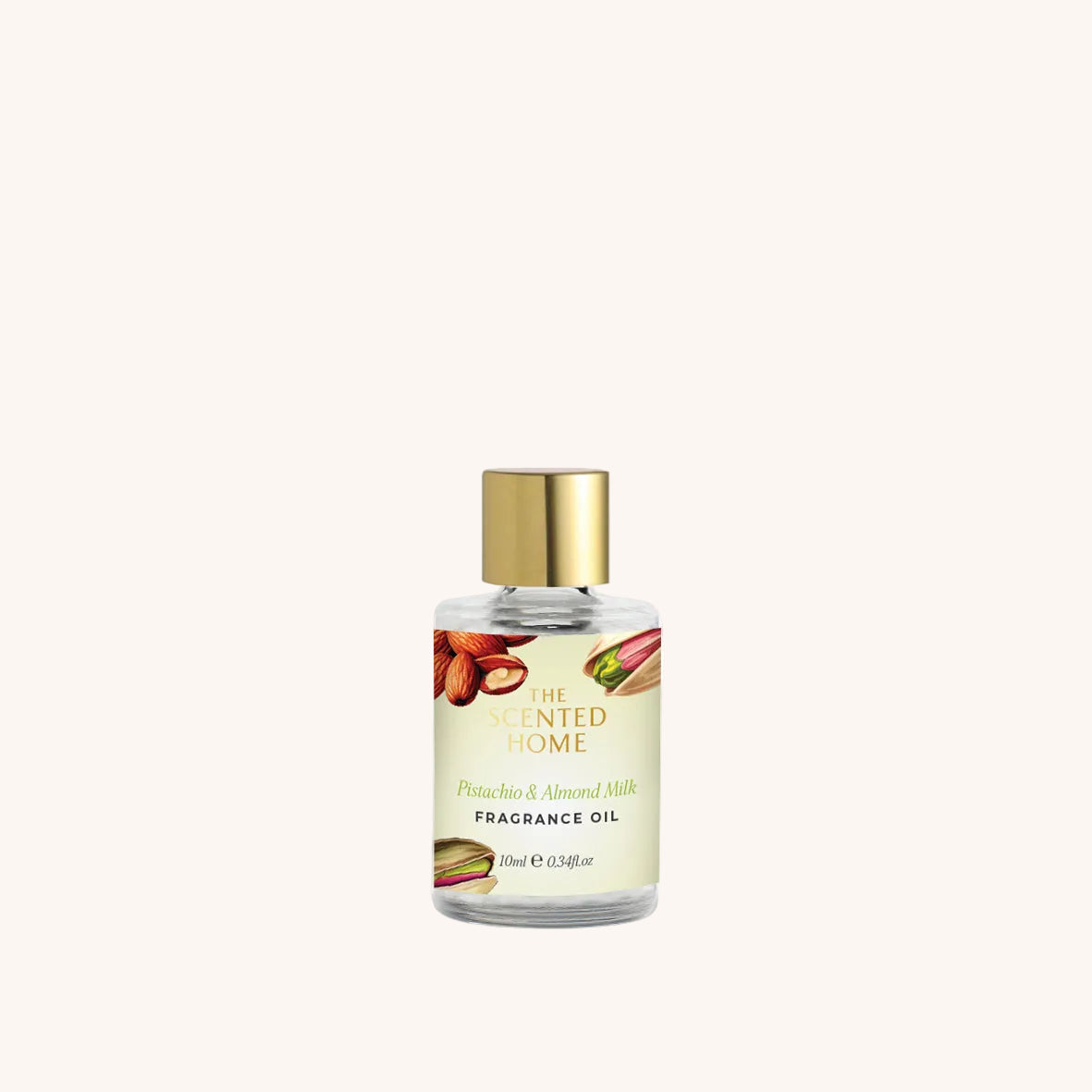 Fragrance oil bottle with gold cap on a white background
