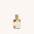 Fragrance oil bottle with gold cap on a white background