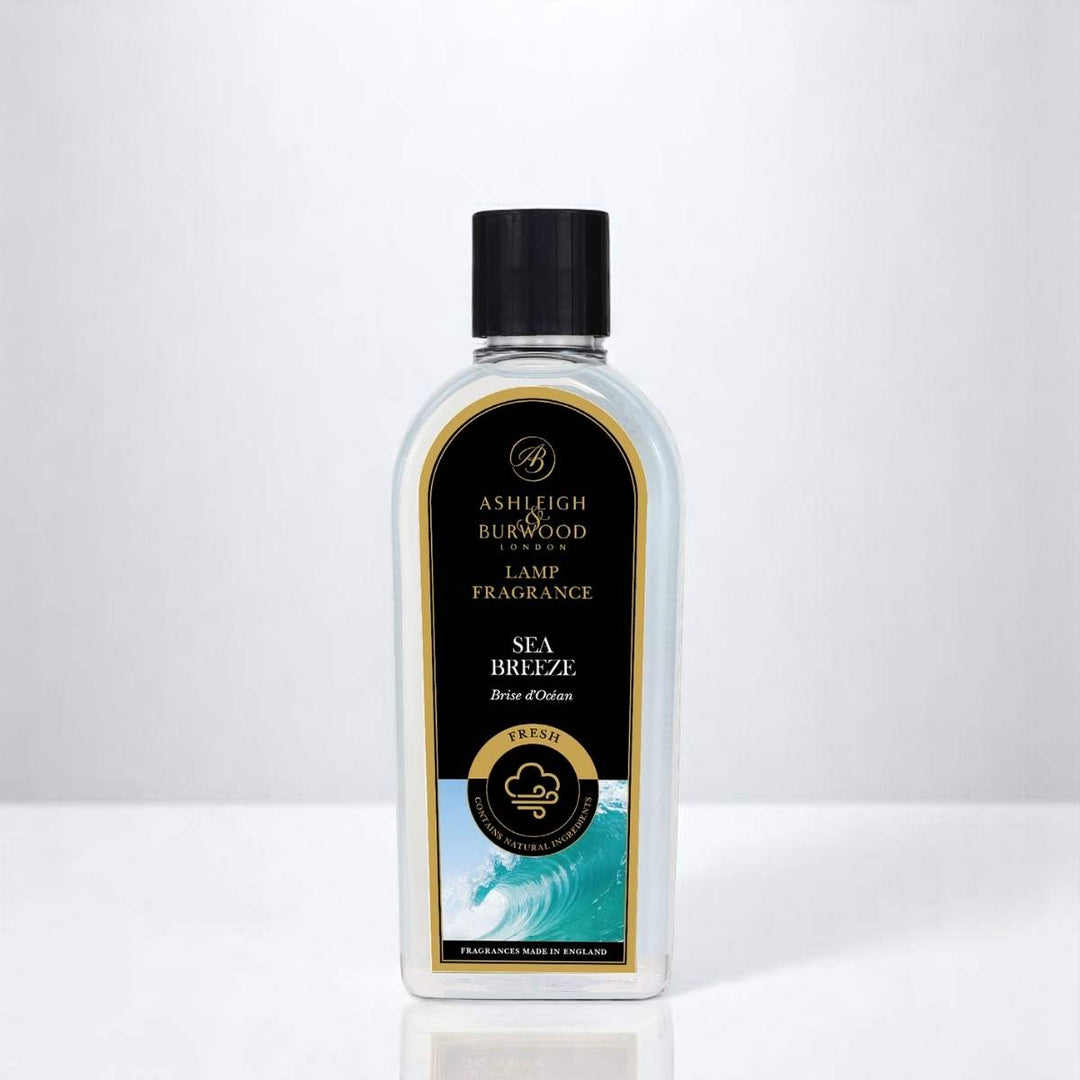 A bottle of Sea Breeze Lamp Fragrance against a neutral white background