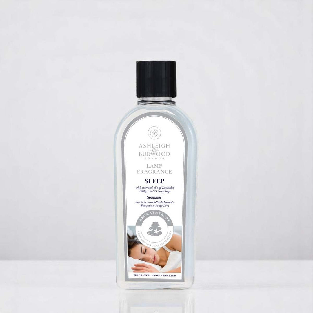 A bottle of Sleep Aromatherapy Lamp Fragrance against a white neutral background