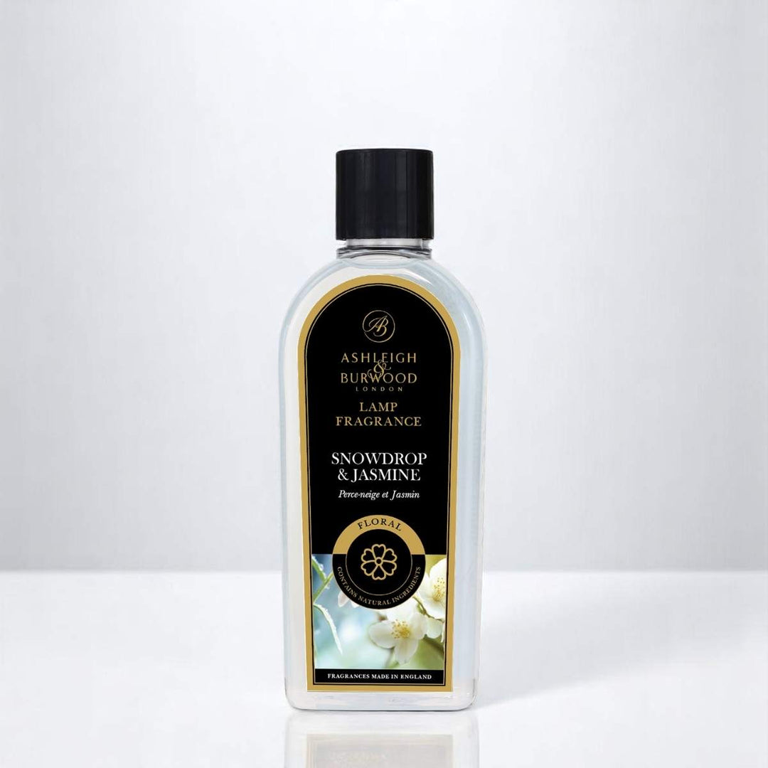 A bottle of Snowdrop & Jasmine Lamp Fragrance against a white neutral background