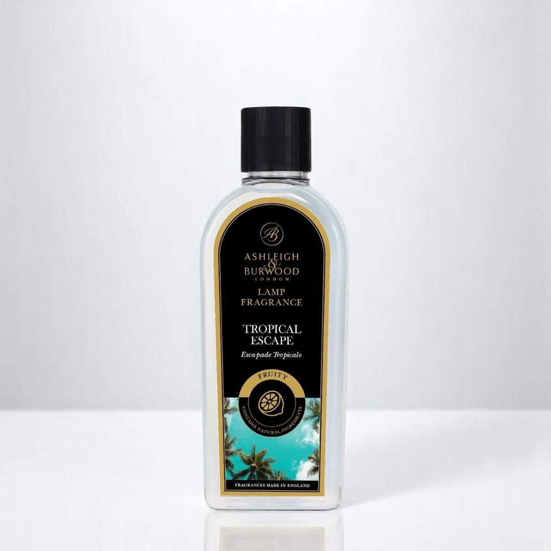 A bottle of Tropical Escape Lamp Fragrance against a white neutral background