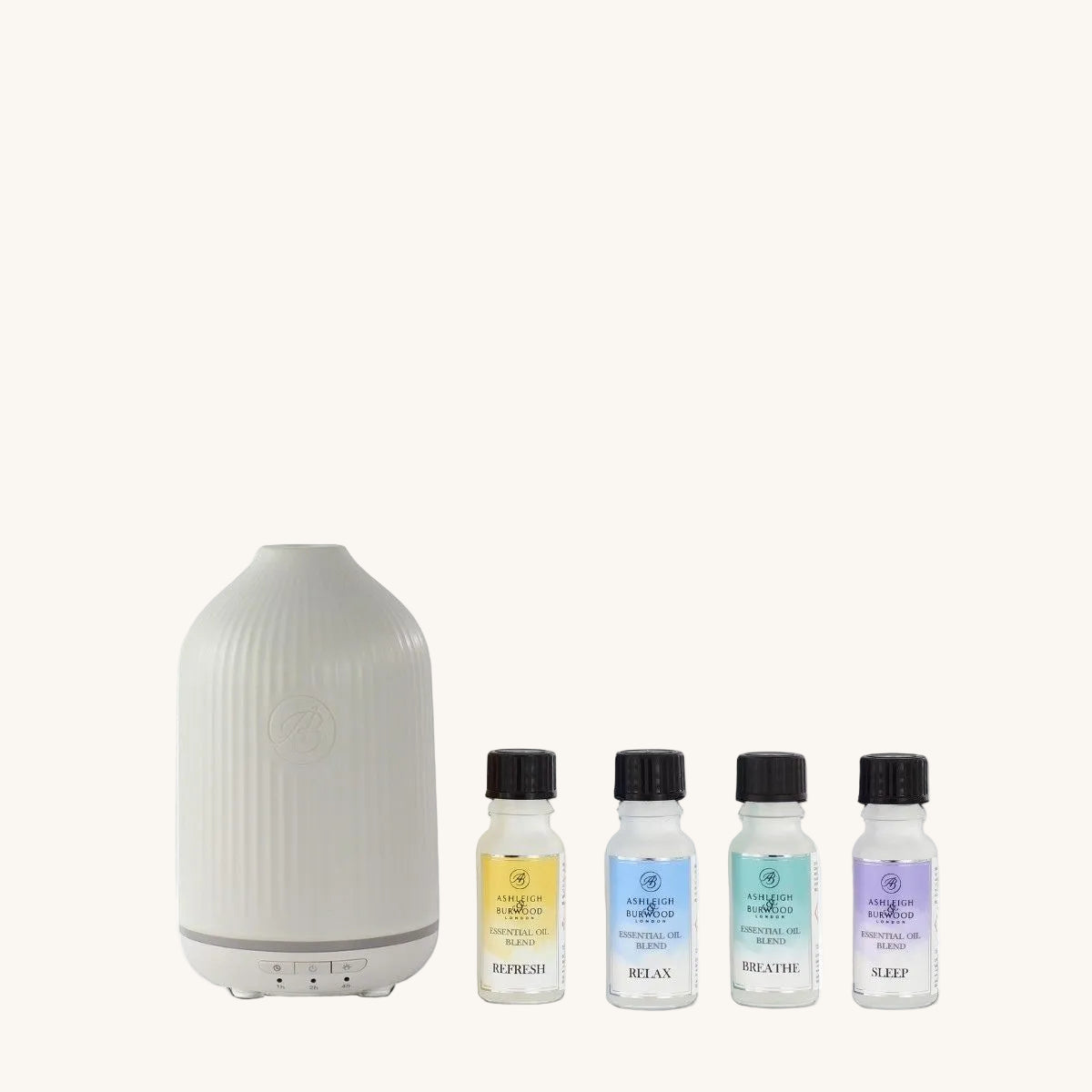 White diffuser with four small bottles of essential oils on a white background