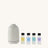 White diffuser with four small bottles of essential oils on a white background