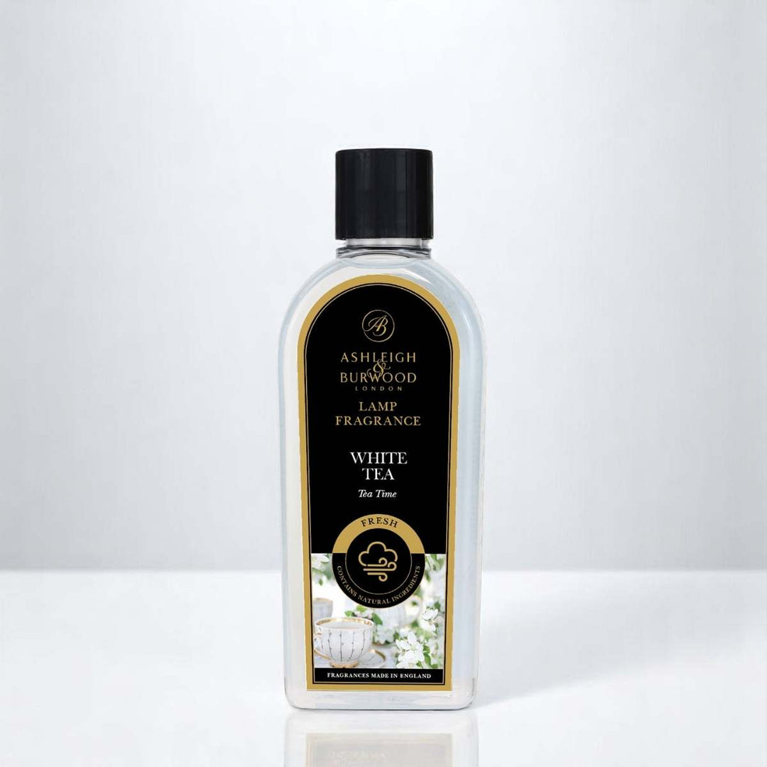 A bottle of White Tea Lamp Fragrance against a white neutral background