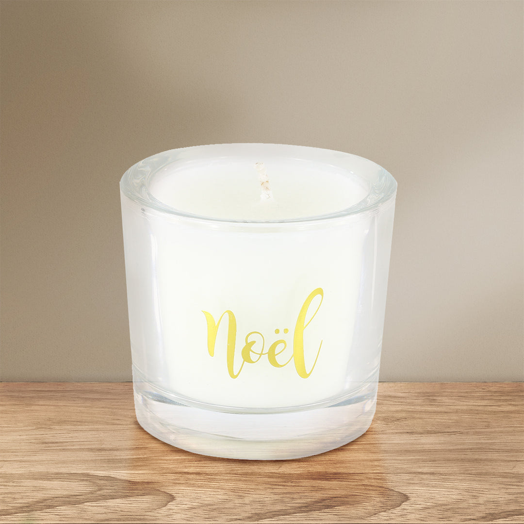 'Noel' Scented Candle on a brown wooden table