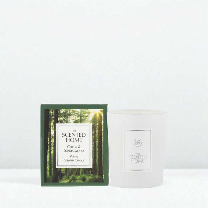 Candle with packaging featuring a forest design on a white background