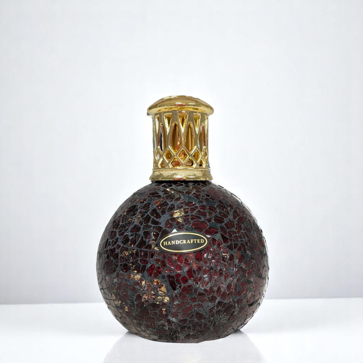 Dragon's Eye Lamp with mosaic design and gold cap on a white background