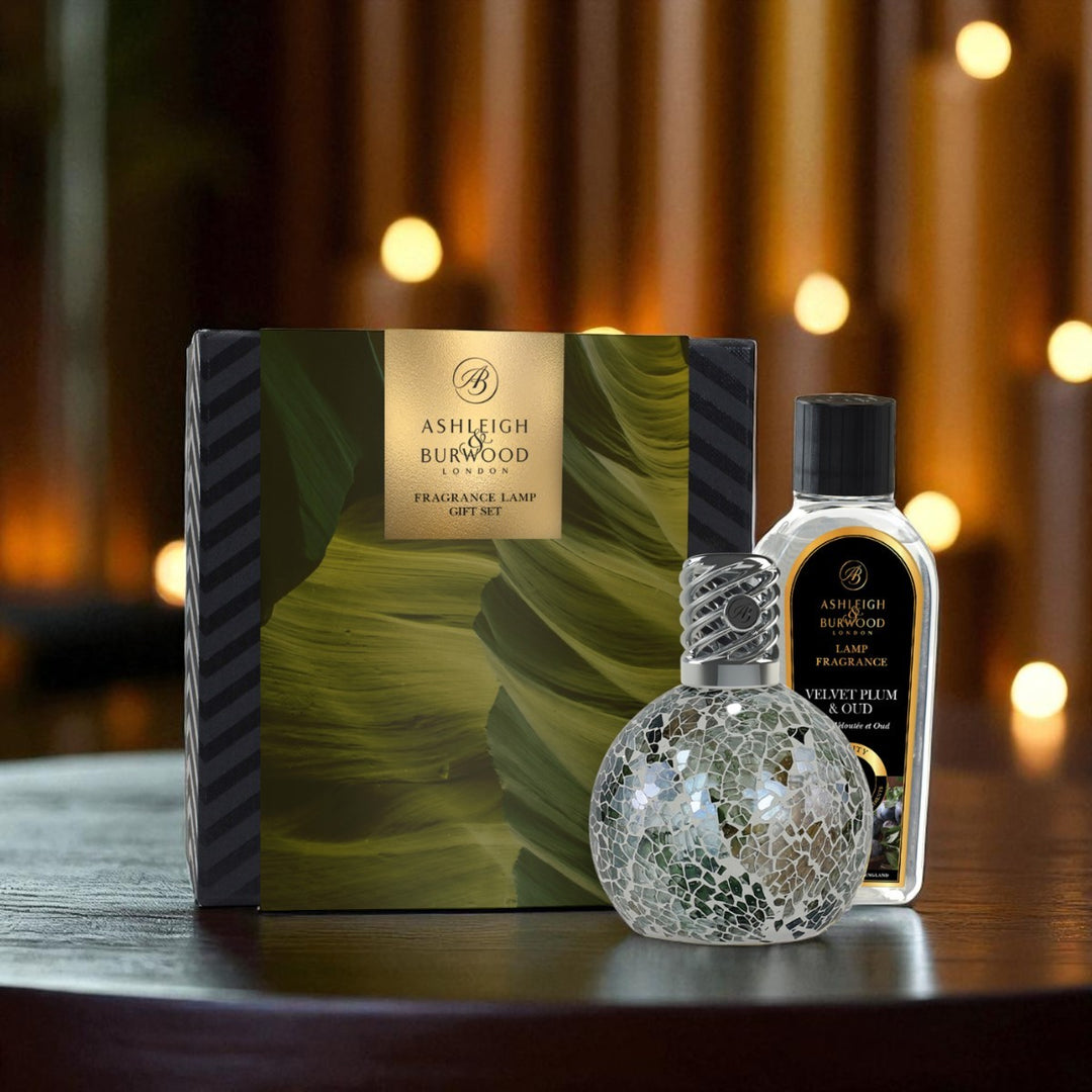 Ashleigh & Burwood fragranced lamp set with decorative bottle on a wooden surface.