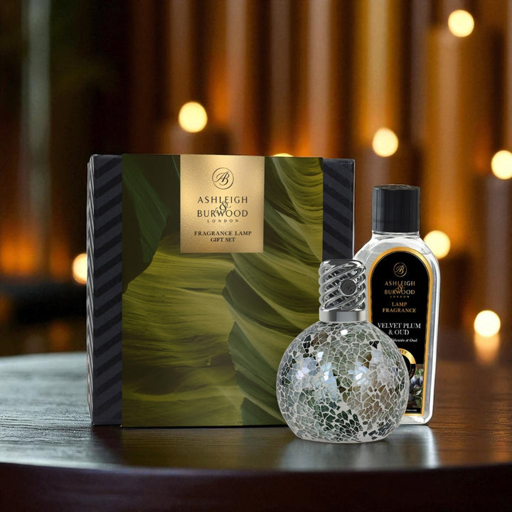 Ashleigh & Burwood fragranced lamp set with decorative bottle on a wooden surface.