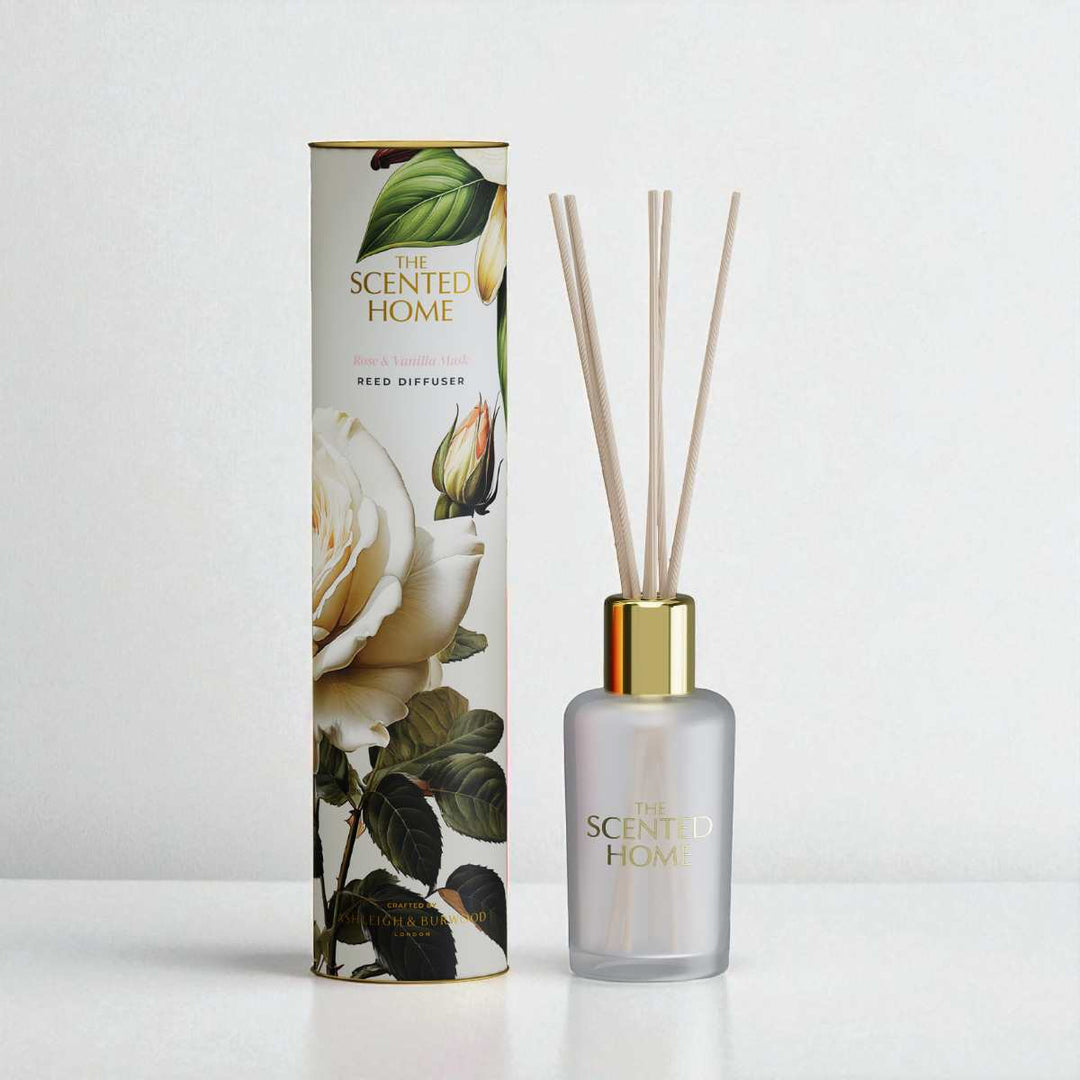 Reed diffuser with floral packaging on a white background