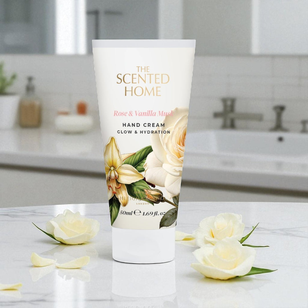 Hand cream tube labeled 'The Scented Home' with floral design on a bathroom counter.