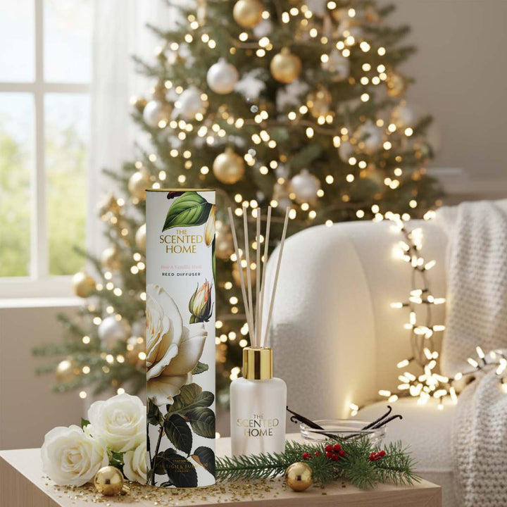 Scented home diffuser with packaging in front of a decorated Christmas tree